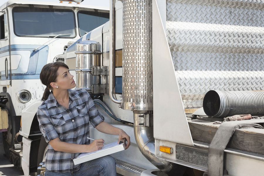 bigstock Woman inspecting flatbed truck 50066150